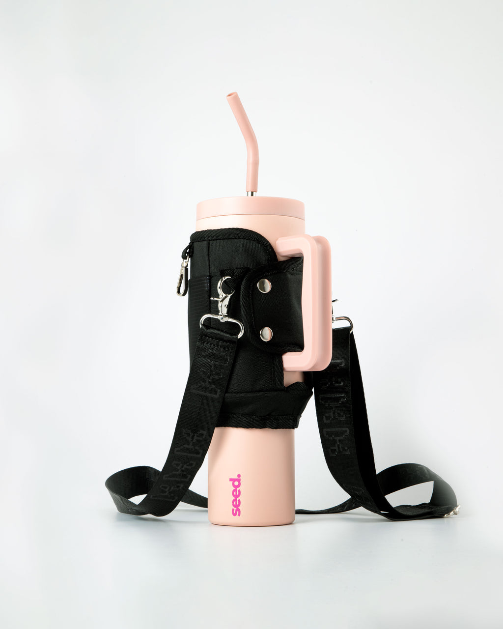 Pink tumbler with black strap and 'seed' branding on a white background 1.2l-stainless-steel-tumbler-baby-pink-carry-all-sleeve-black-back baby pink & blackhole