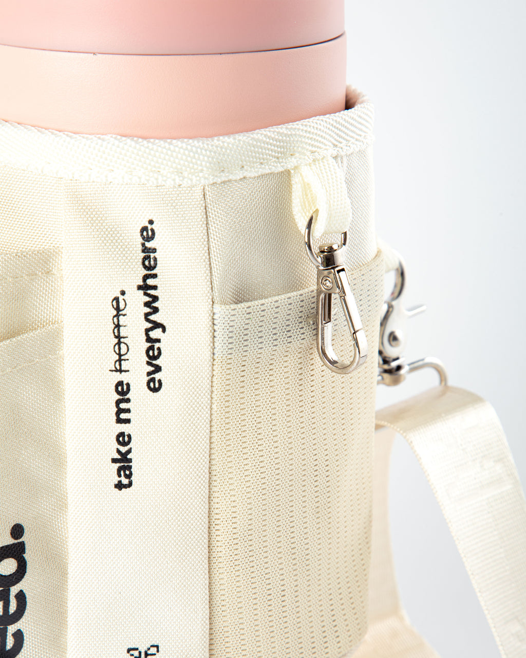 Beige tote bag with 'take me home. everywhere.' text and a keychain on a white background 1.2l-stainless-steel-tumbler-baby-pink-carry-all-sleeve-white-side-mesh-pocket-and-keychain-holder baby pink & milkyway