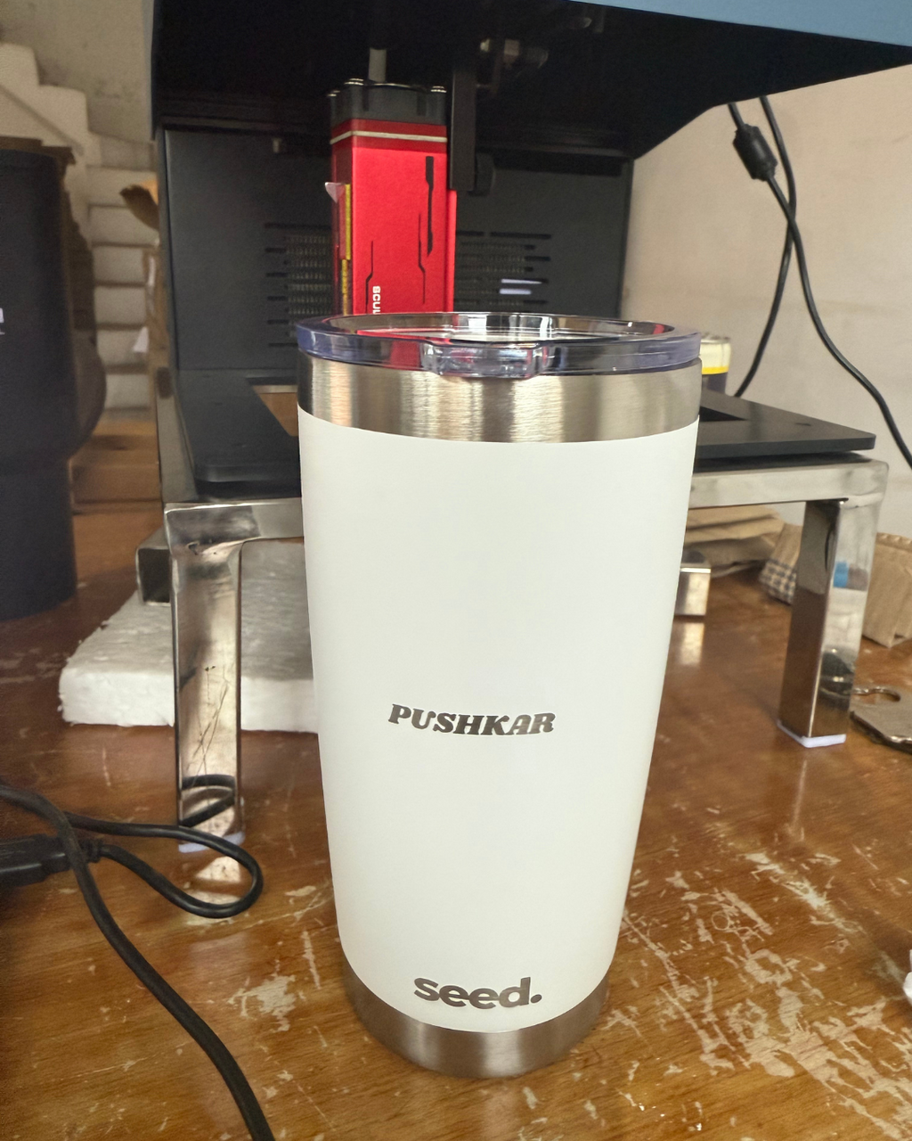 Personalised white tumbler with 'Pushkar' laser engraved on it and 'seed' branding on a wooden surface. stainless steel tumbler 600mL moonlight insulated stainless steel travel coffee mug 600mL 