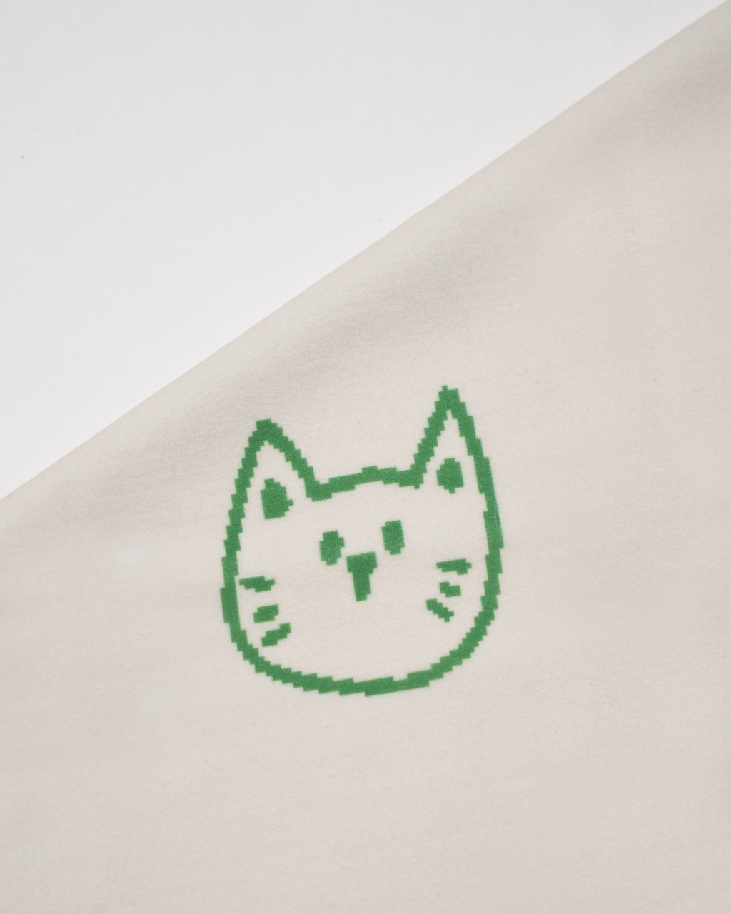 Green printed cat face design on a beige fabric background Hold Up Magic Self Adhesive Wrap  Organiser Cat In The Bag
