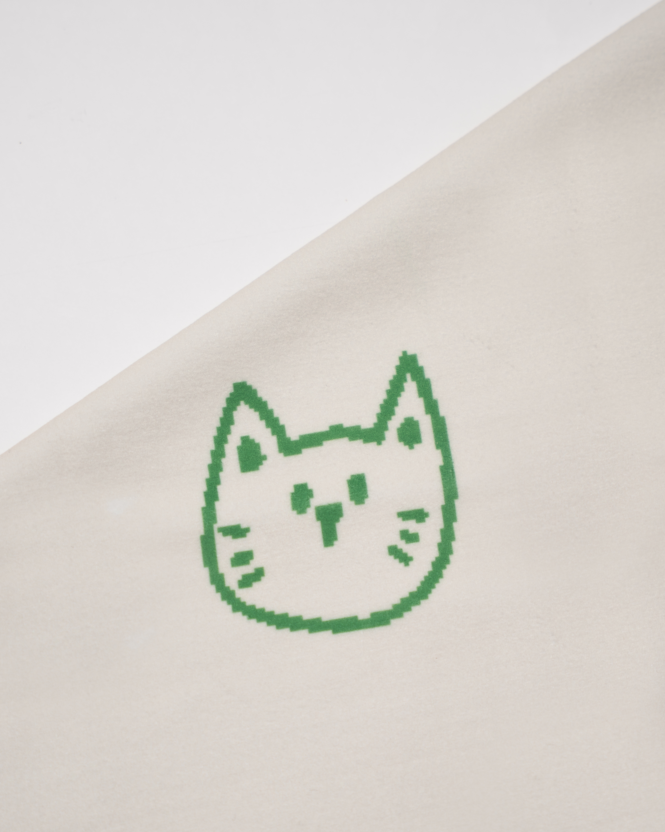 Green printed cat face design on a beige fabric background Hold Up Magic Self Adhesive Wrap  Organiser Cat In The Bag